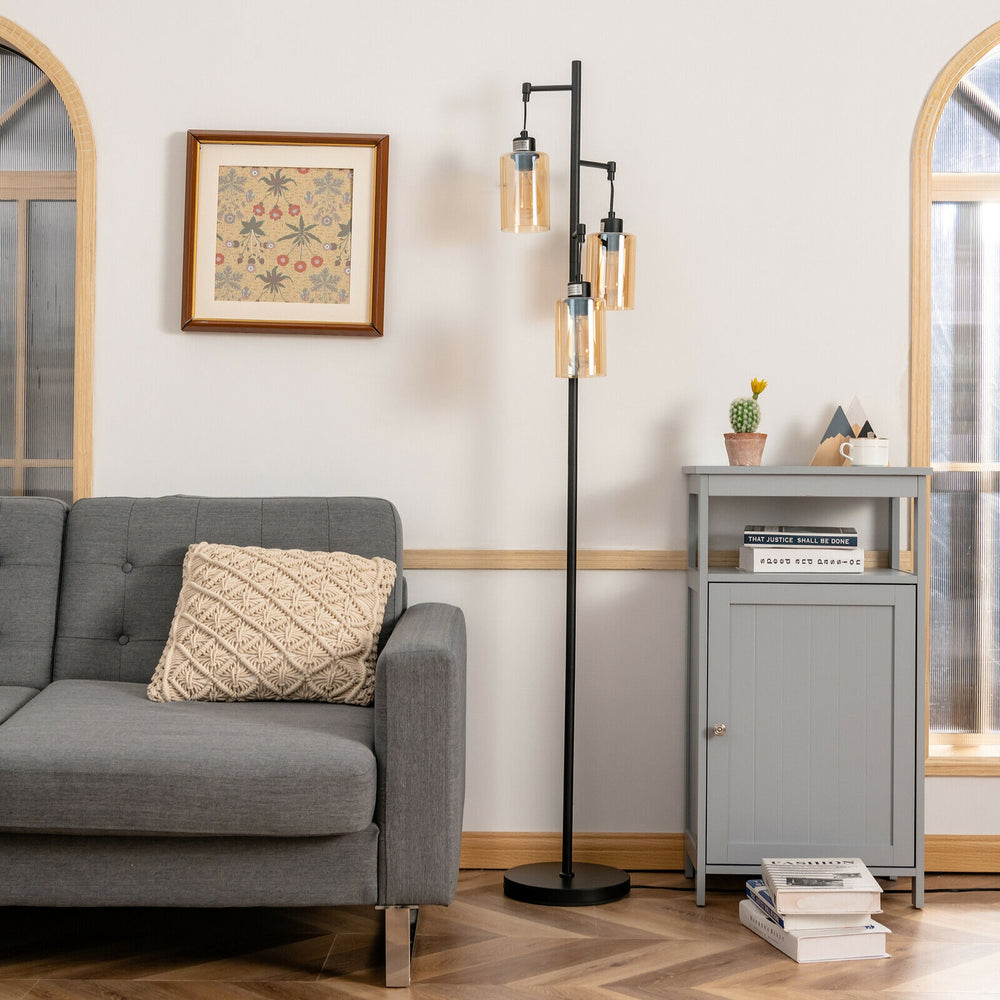 Retro floor lamp with three amber glass shades, featuring a stable iron base, perfect for living room or office decor.