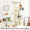Multi-level cat tree condo in cream white with sisal posts, plush pads, and dangling toys for feline fun and rest.