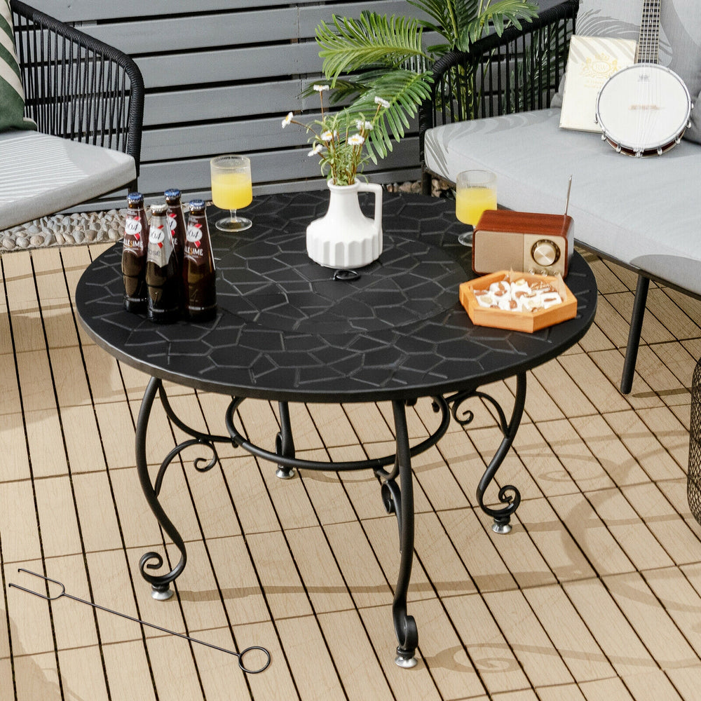 Round patio fire pit dining table with a black heat-resistant surface, ideal for outdoor gatherings and BBQs.