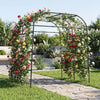Tall black metal garden arch trellis for climbing plants, offering vertical support and enhancing garden aesthetics.