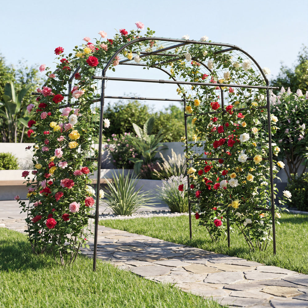 Tall black metal garden arch trellis for climbing plants, offering vertical support and enhancing garden aesthetics.