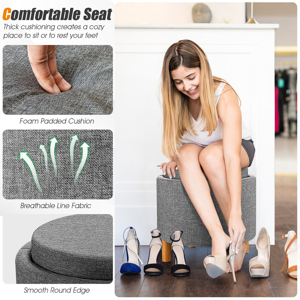 Round gray fabric storage ottoman with removable lid, padded seat, and wooden tray for versatile use in any room.