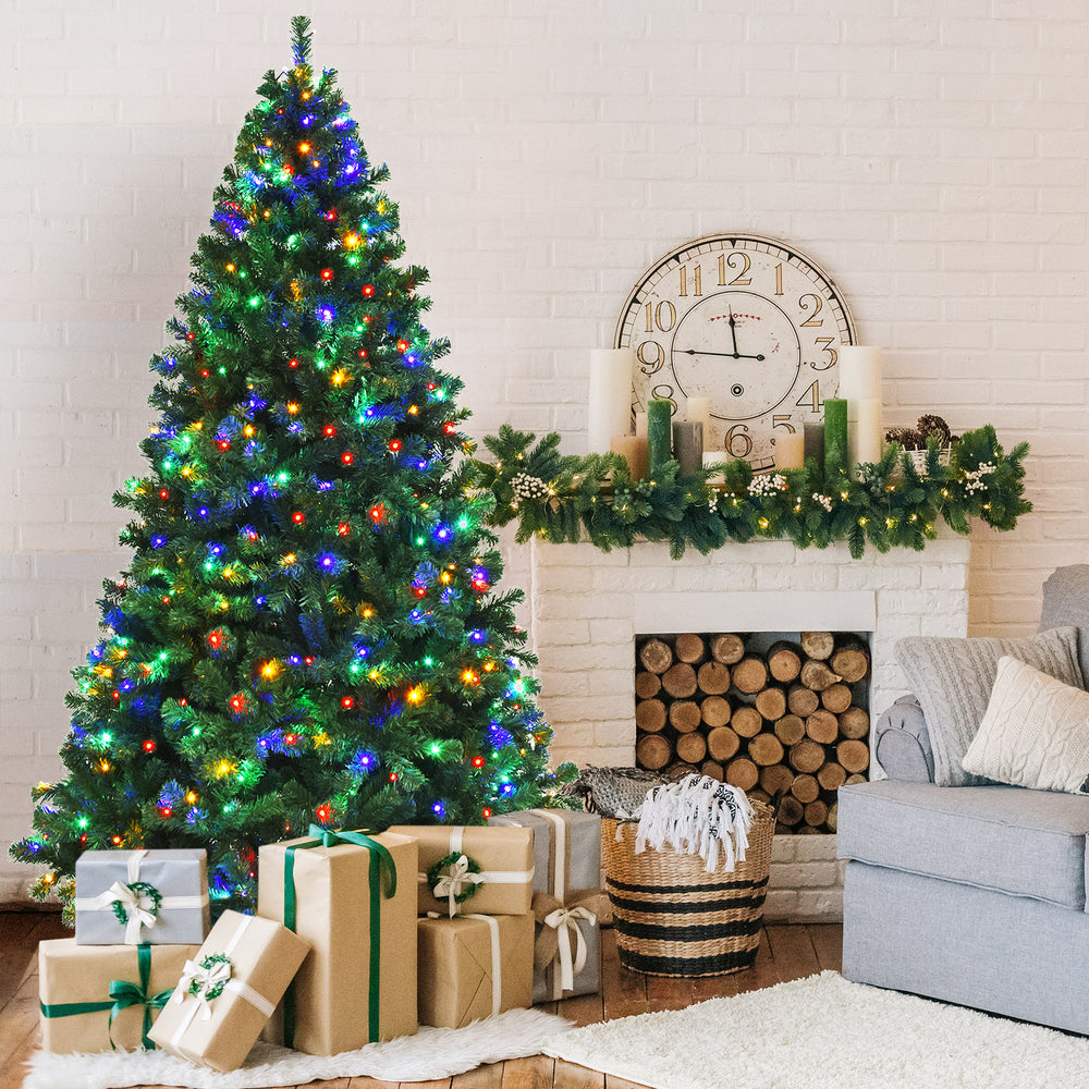 7.5 feet pre-lit artificial spruce Christmas tree with 550 multicolor lights, enhancing a cozy indoor holiday scene.