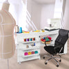 Folding sewing table with wheels, white MDF, features three storage bins and an extra shelf for sewing machine and.