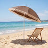 Brown 7 FT patio umbrella with boho fringe tassels, shown beside a beach chair, perfect for outdoor relaxation by the.