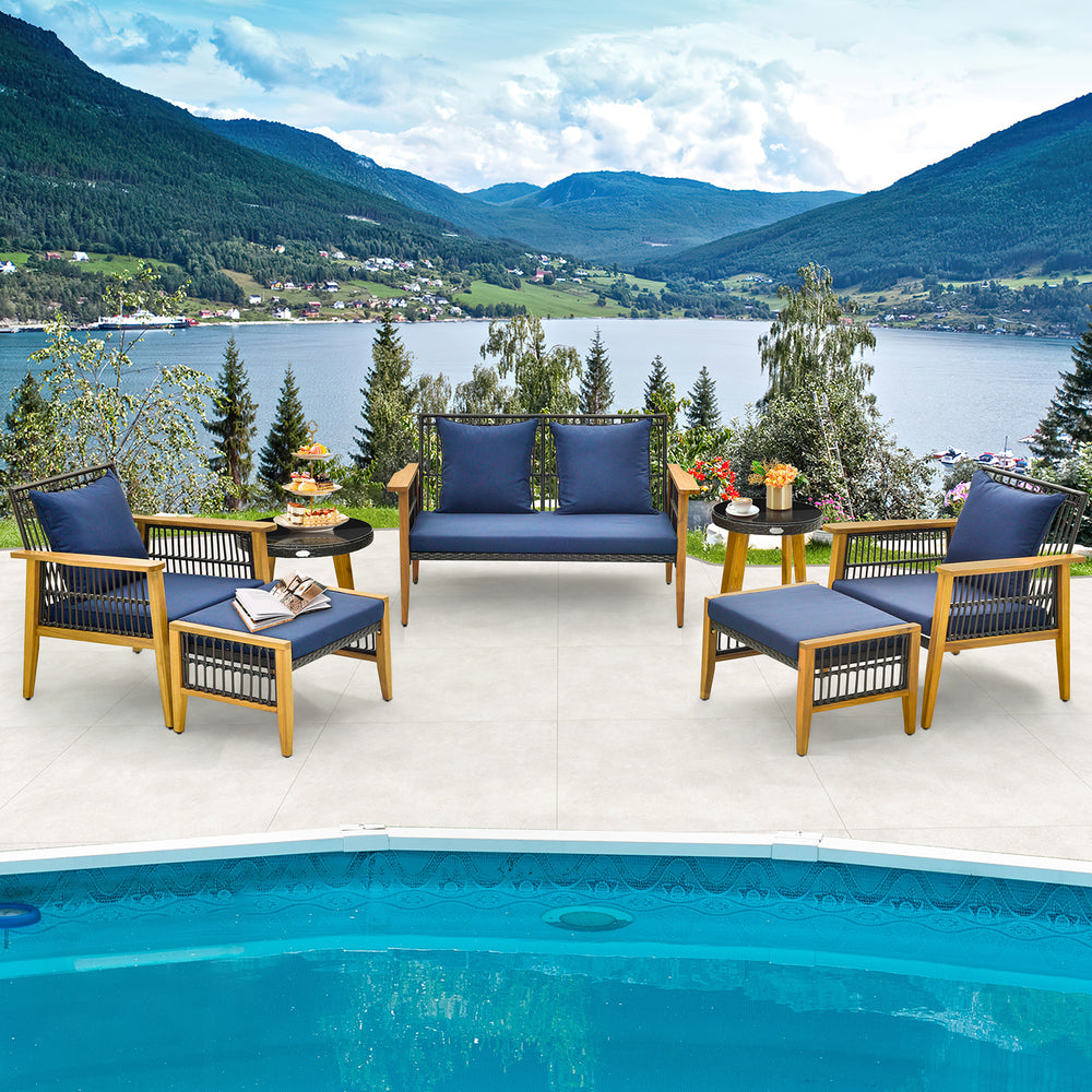 7-piece outdoor conversation set featuring a stable acacia wood frame and navy cushions, ideal for poolside relaxation.