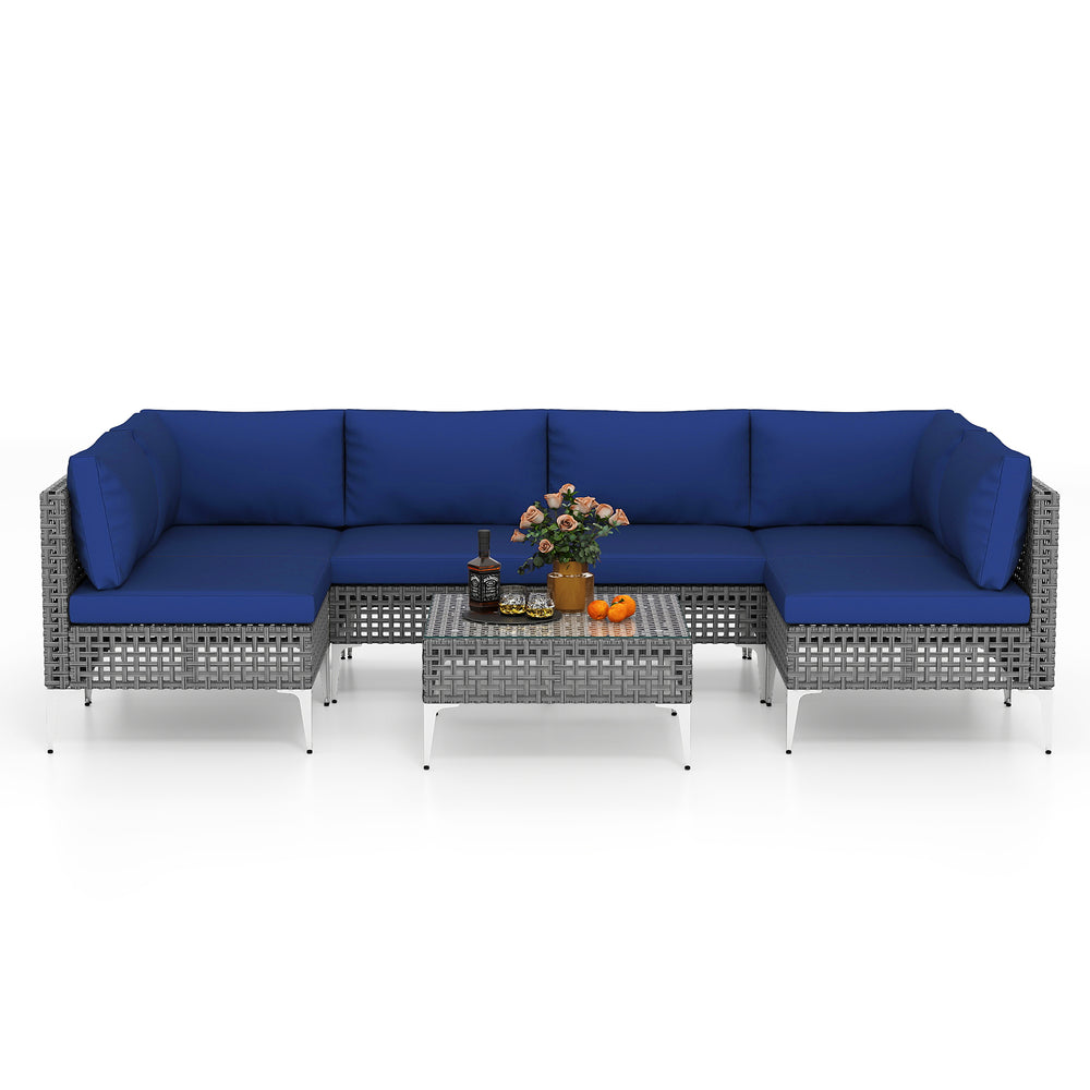 7-piece outdoor furniture set with navy cushions, featuring PE rattan and a tempered glass coffee table for backyard.