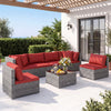 7-piece PE rattan patio set with red cushions and glass table, ideal for outdoor relaxation and versatile layouts.