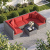 Modular 7-piece PE rattan patio set with red cushions and glass table, ideal for outdoor garden or poolside use.