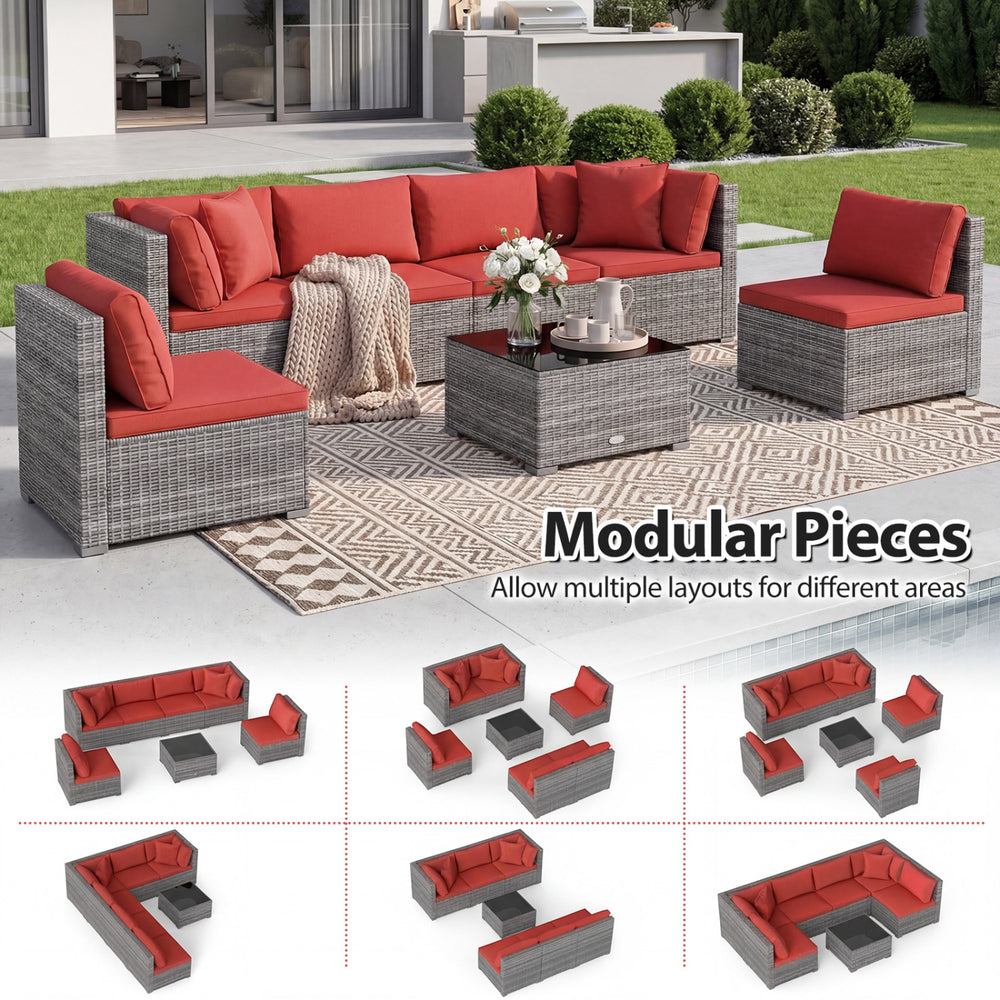 Modular 7-piece PE rattan patio set with red cushions and glass table, perfect for outdoor relaxation and versatile layouts.