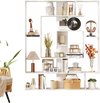 7-tier white bookshelf with layered compartments and geometric design, ideal for home office or living room display.
