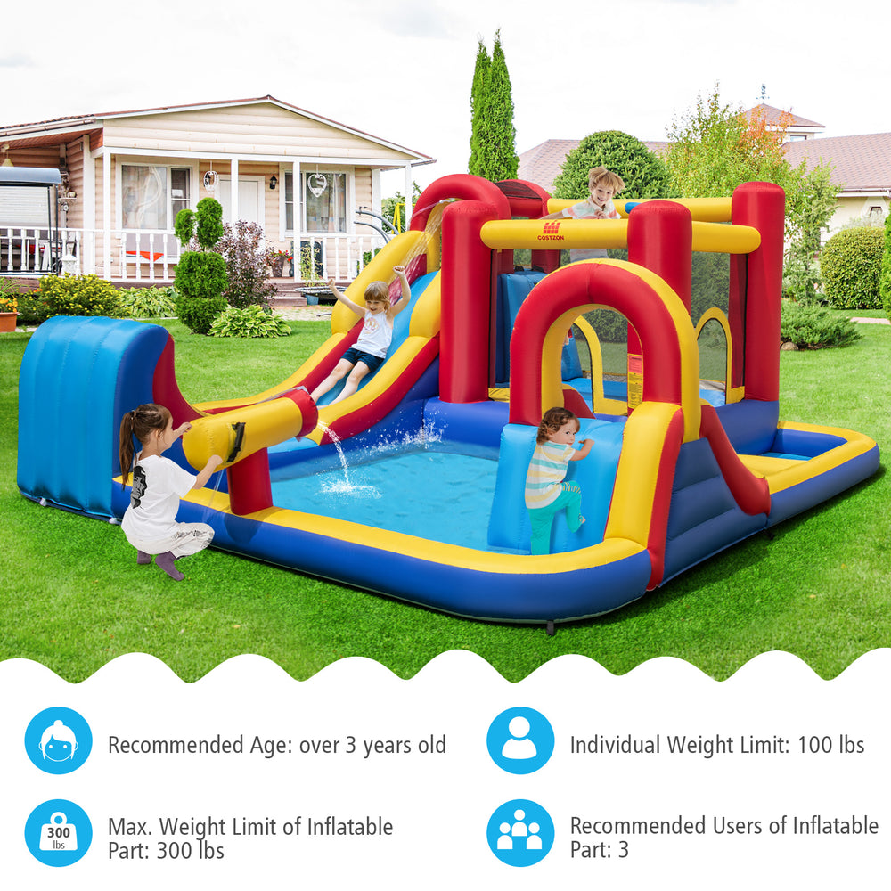 Outdoor inflatable bounce house with water slides, splash pools, and climbing wall for kids' fun in the backyard.