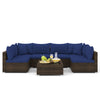 Sectional sofa set with navy cushions, PE rattan material, and coffee table, perfect for outdoor patio relaxation.