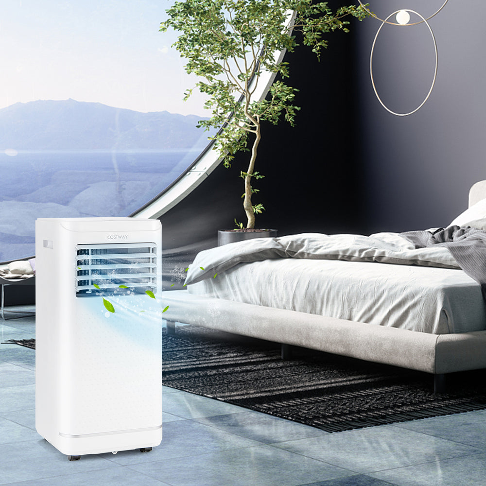 Portable 8000 BTU air conditioner in a modern bedroom, featuring cooling, dehumidifying, and fan modes for versatile.
