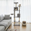 Tall light gray cat tree with two large condos, plush perches, and dangling toys for multiple cats to enjoy.