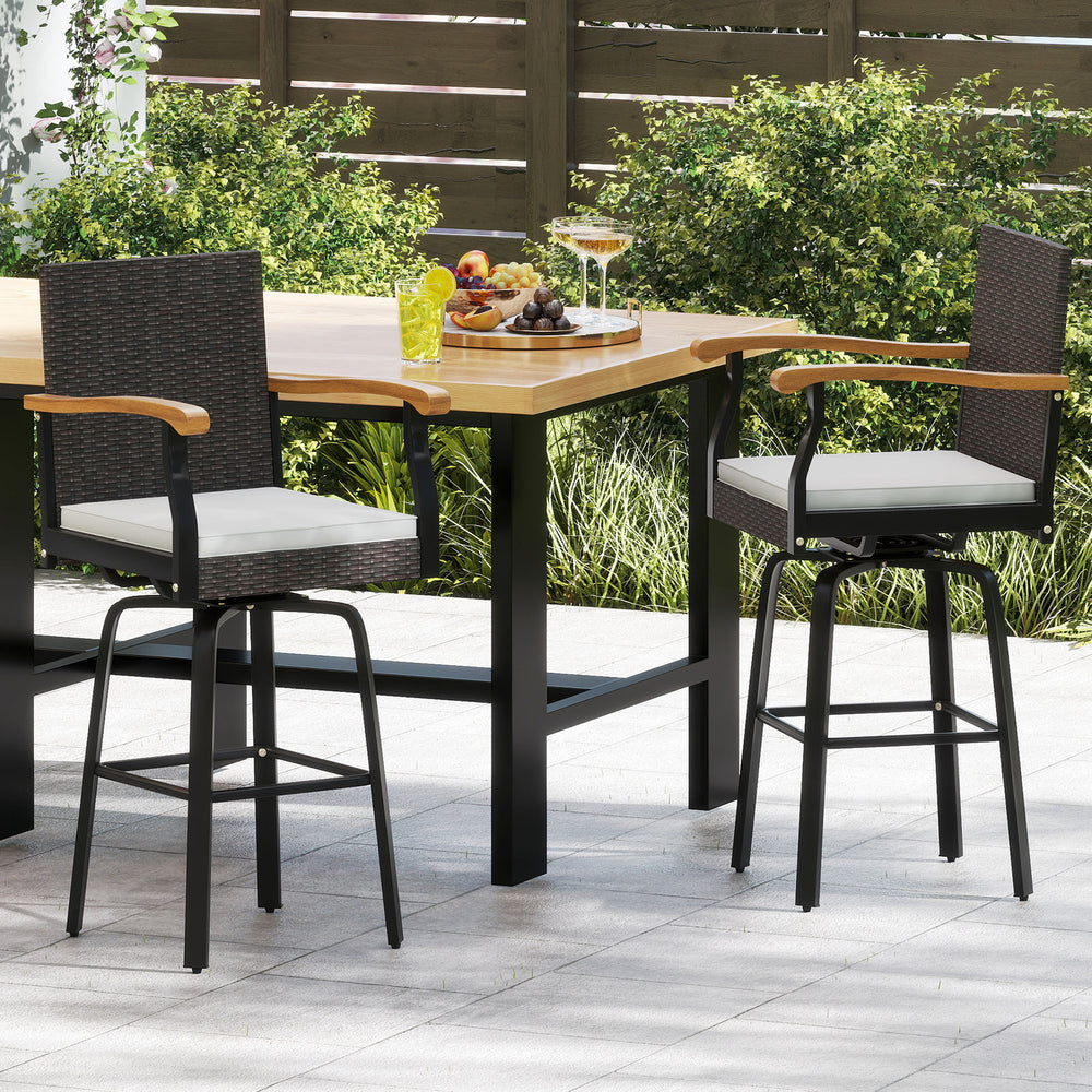 Two One Outdoor 360° swivel bar stools with brown PE rattan and acacia wood armrests, perfect for backyard or poolside.