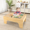 Child playing on the 84-piece train and building block table with reversible top, featuring a spacious design for.