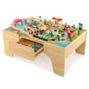 Wooden train and activity table with 84 pieces, reversible top, and storage drawer for kids' play and learning.