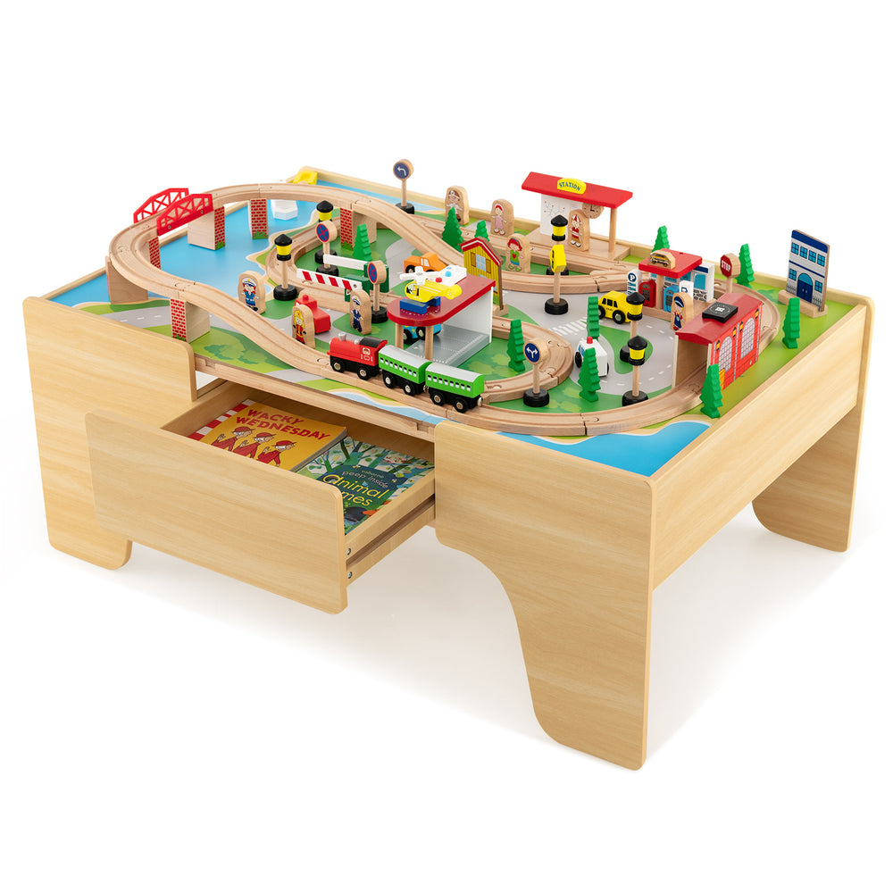 Wooden train and activity table with 84 pieces, reversible top, and storage drawer for kids' play and learning.