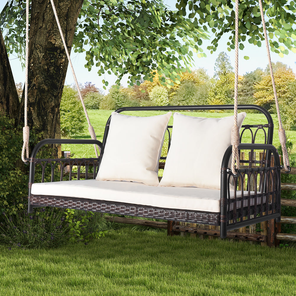 Wicker hanging porch swing with white cushions, durable PE wicker, seats 2, perfect for garden or backyard relaxation.