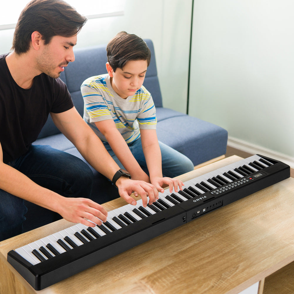 88-key foldable electric keyboard piano in black, featuring dual speakers and wireless MIDI, perfect for music learning.