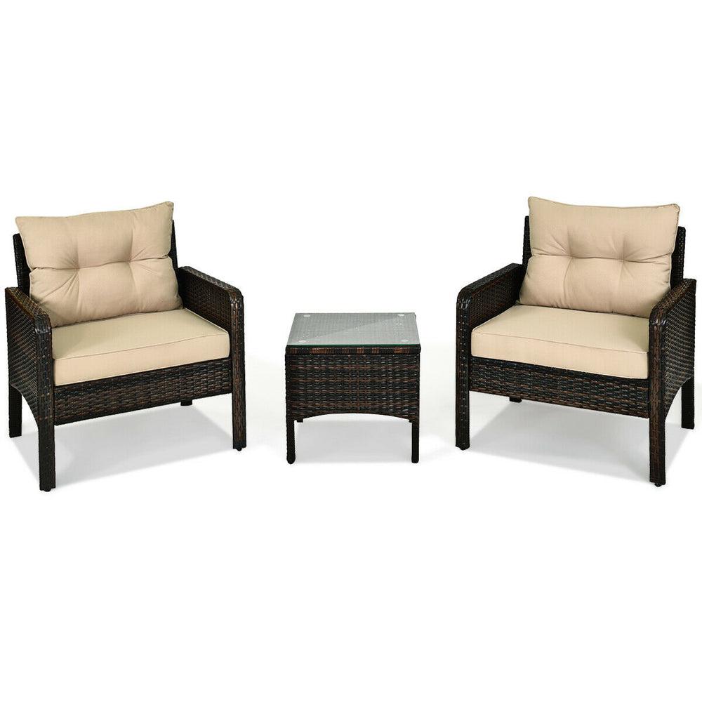 Two beige cushioned chairs and a glass-top table from a 3-piece outdoor patio rattan conversation set for relaxation.