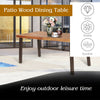Side view of a rustic acacia wood dining table with steel legs, featuring adjustable foot pads for enhanced stability.
