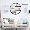 Circular wall-mounted 4-tier rack in black metal, ideal for displaying small objects in modern minimalist interiors.