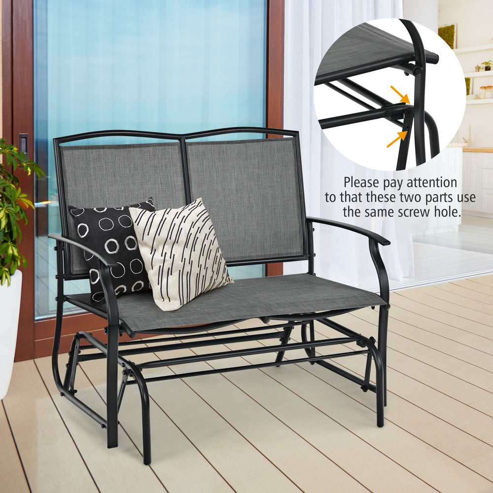 Gray iron patio rocking chair for two with a durable metal frame, perfect for outdoor relaxation in your backyard.