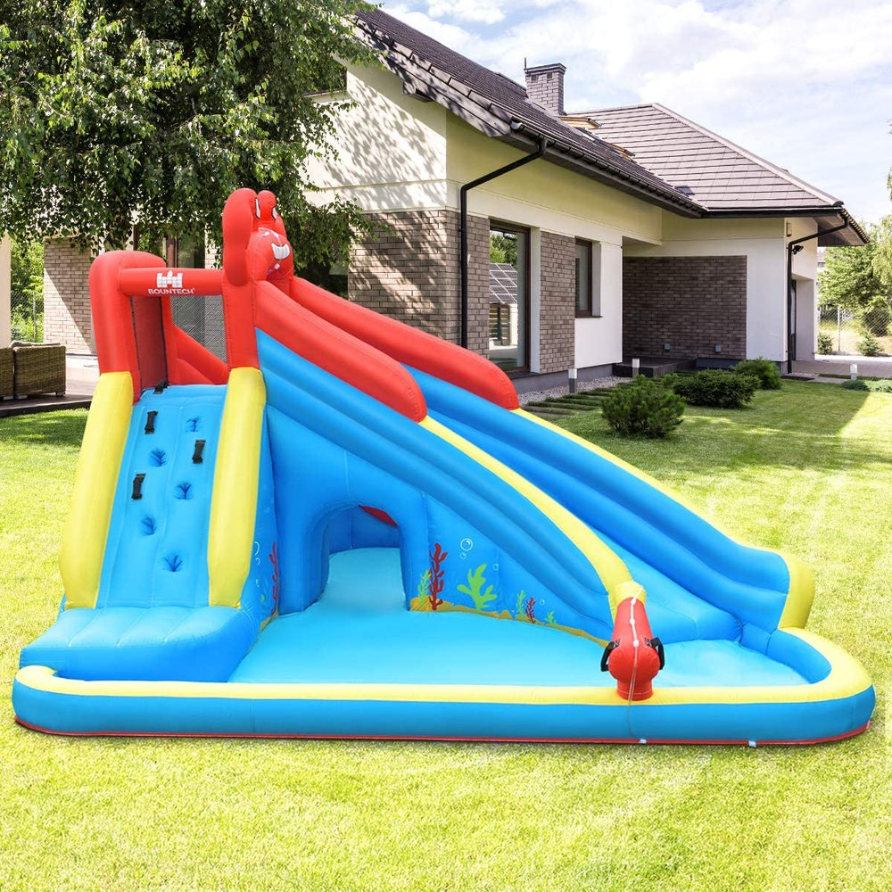 Inflatable water slide bounce house in crab theme with two slides, climbing wall, and water cannon for outdoor fun.