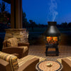 Patio wood burning chimney fireplace in cast iron, featuring a round roof and mesh screening for outdoor warmth.