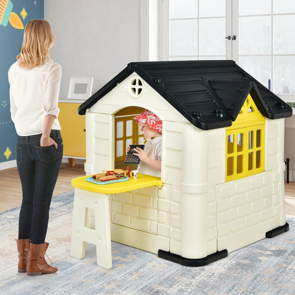 Kid’s playhouse with yellow accents, featuring open doors and windows, perfect for indoor and outdoor imaginative play.