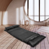 Foldable black PU leather leisure floor sofa bed with two pillows, adjustable for reading or relaxing in small spaces.