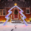 Christmas tree-shaped archway with LED lights and top star, ideal for festive yard decoration in winter settings.
