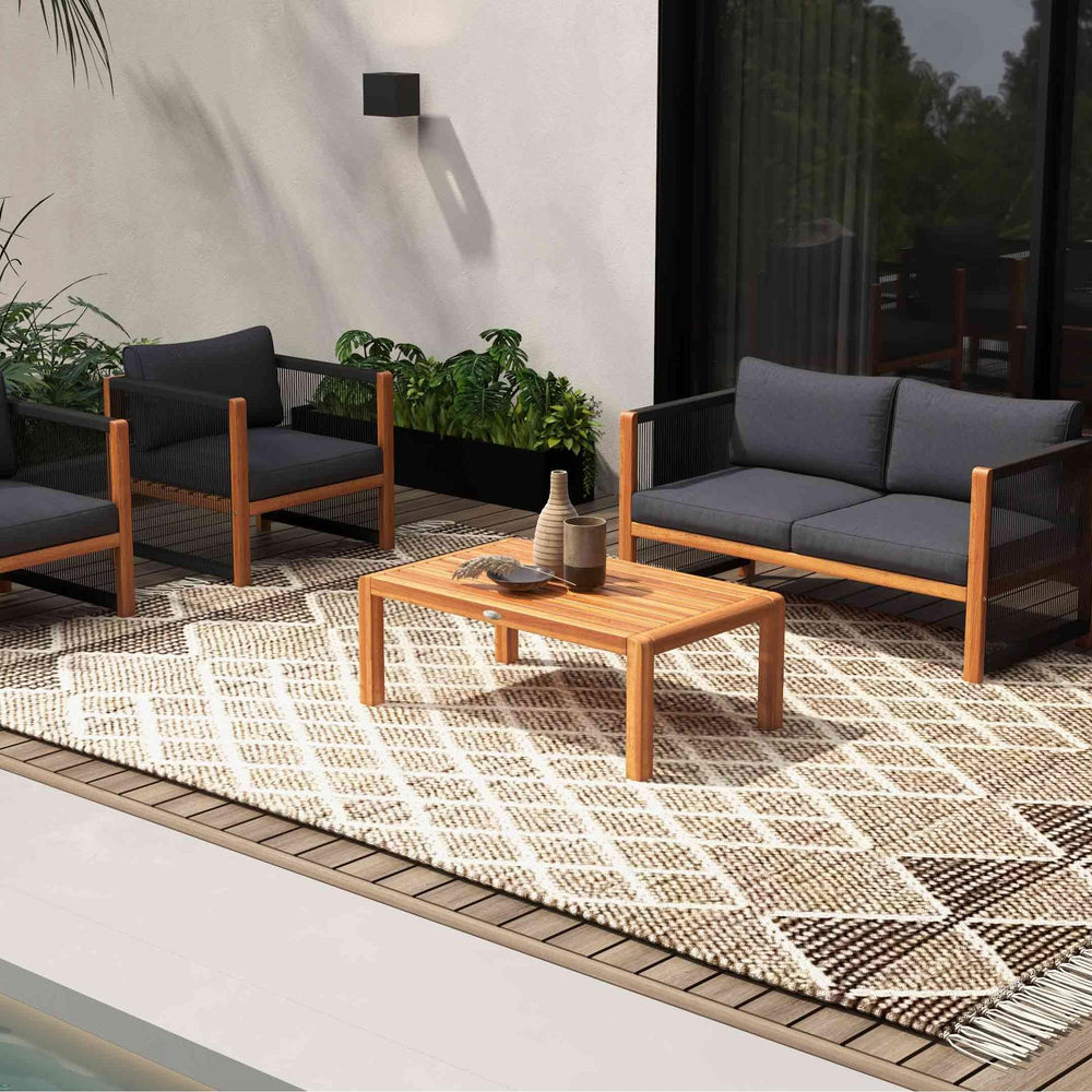 Outdoor conversation set featuring acacia wood frame and thick cushions, perfect for patio relaxation.