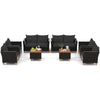 Outdoor conversation set featuring 8 pieces of black PE rattan furniture with soft cushions and a storage coffee table.