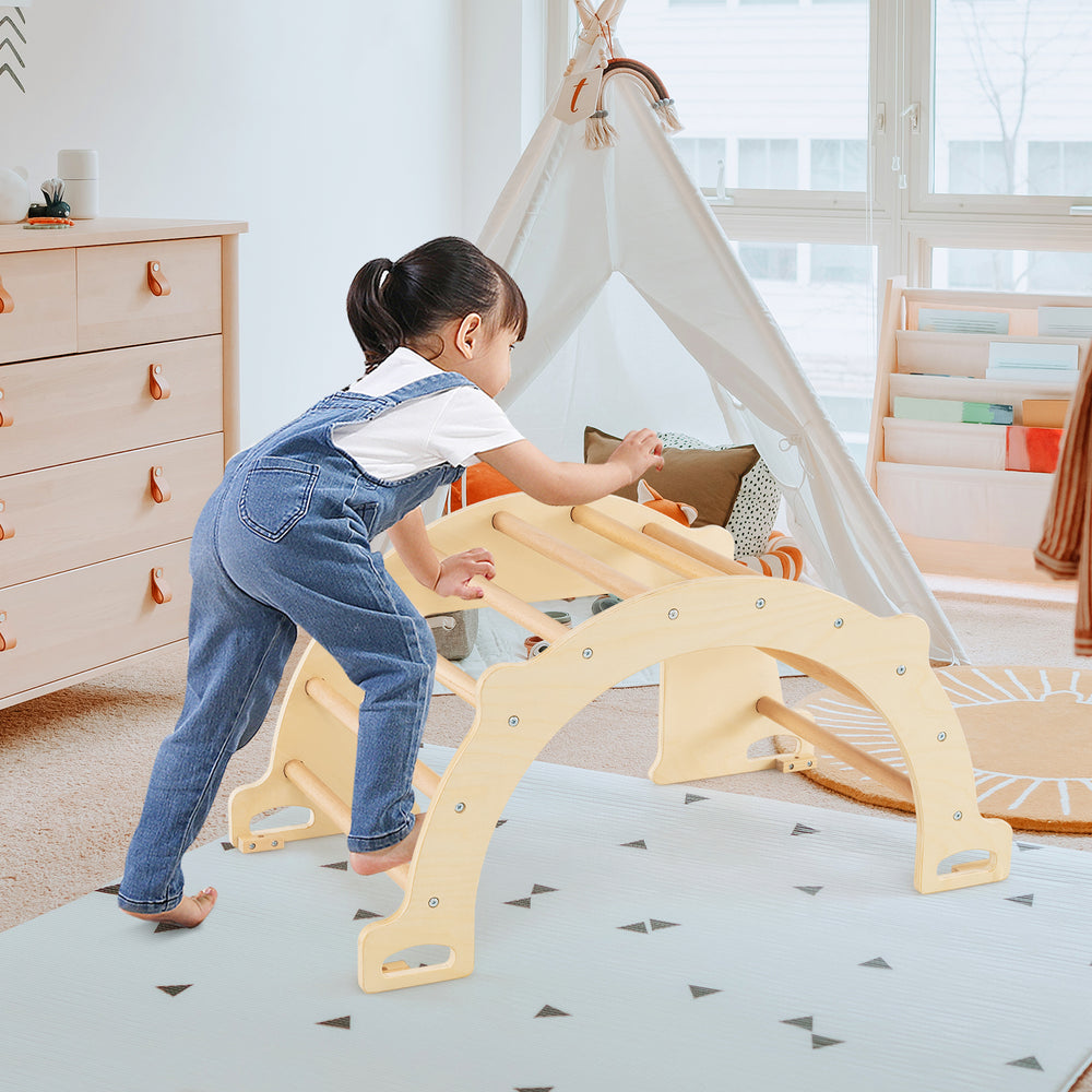 Child climbing on the 8-in-1 natural beech wood climbing arch sensory table, promoting motor skills and balance.