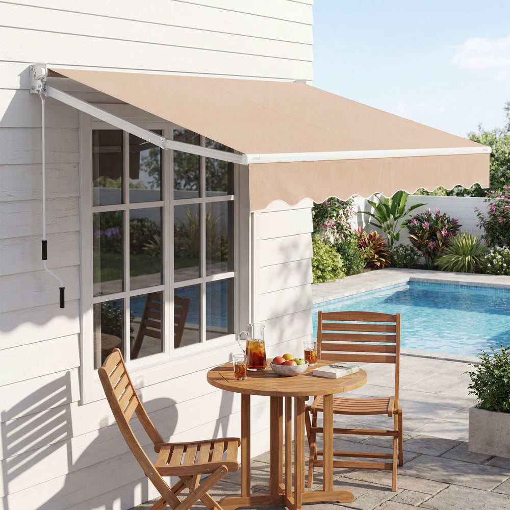 Retractable 8 x 6.6 feet beige patio awning with manual crank, providing UV protection and a stylish wavy edge for outdoor spaces.