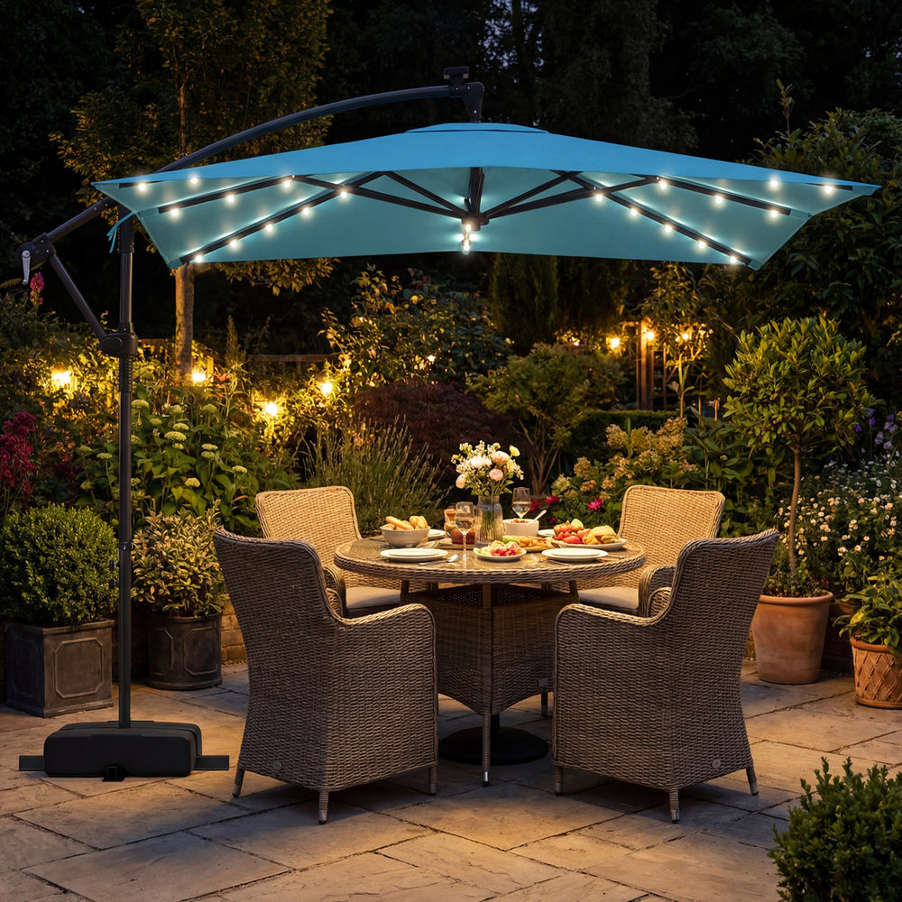 Turquoise 8 x 8 ft solar LED offset cantilever patio umbrella with 360° rotation, providing shade for outdoor dining.
