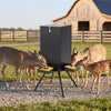 Gravity deer feeder in black with 4 feeding trays and a stable 4-leg stand for outdoor use and multiple animal feeding.
