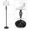 Black metal floor lamp with white fabric shade, featuring a hollow pattern design, ideal for traditional decor.
