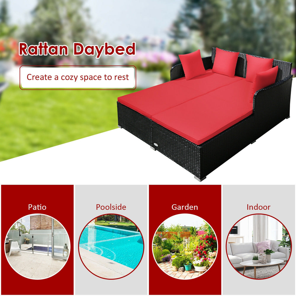 Spacious outdoor rattan daybed with red upholstered cushions, perfect for patio relaxation and comfort.