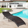 Folding patio lounger chair in dark wicker with beige cushion, designed for poolside relaxation and easy storage.