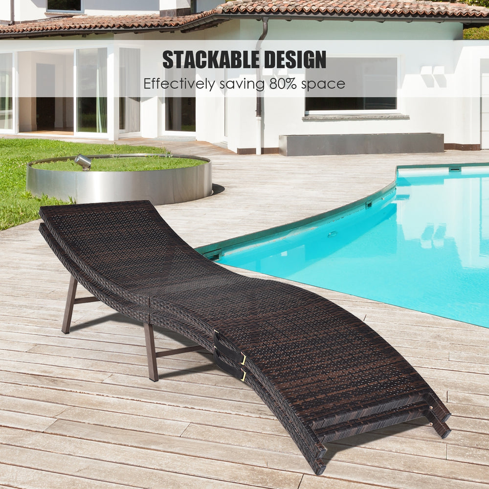 Folding patio lounger chair in dark wicker with beige cushion, designed for poolside relaxation and easy storage.
