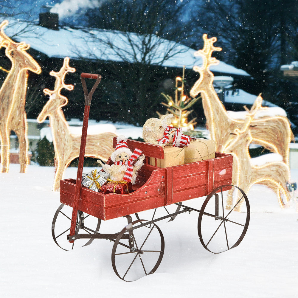 Red wooden wagon plant bed with wheels, featuring two planting sections, perfect for garden or yard decoration.