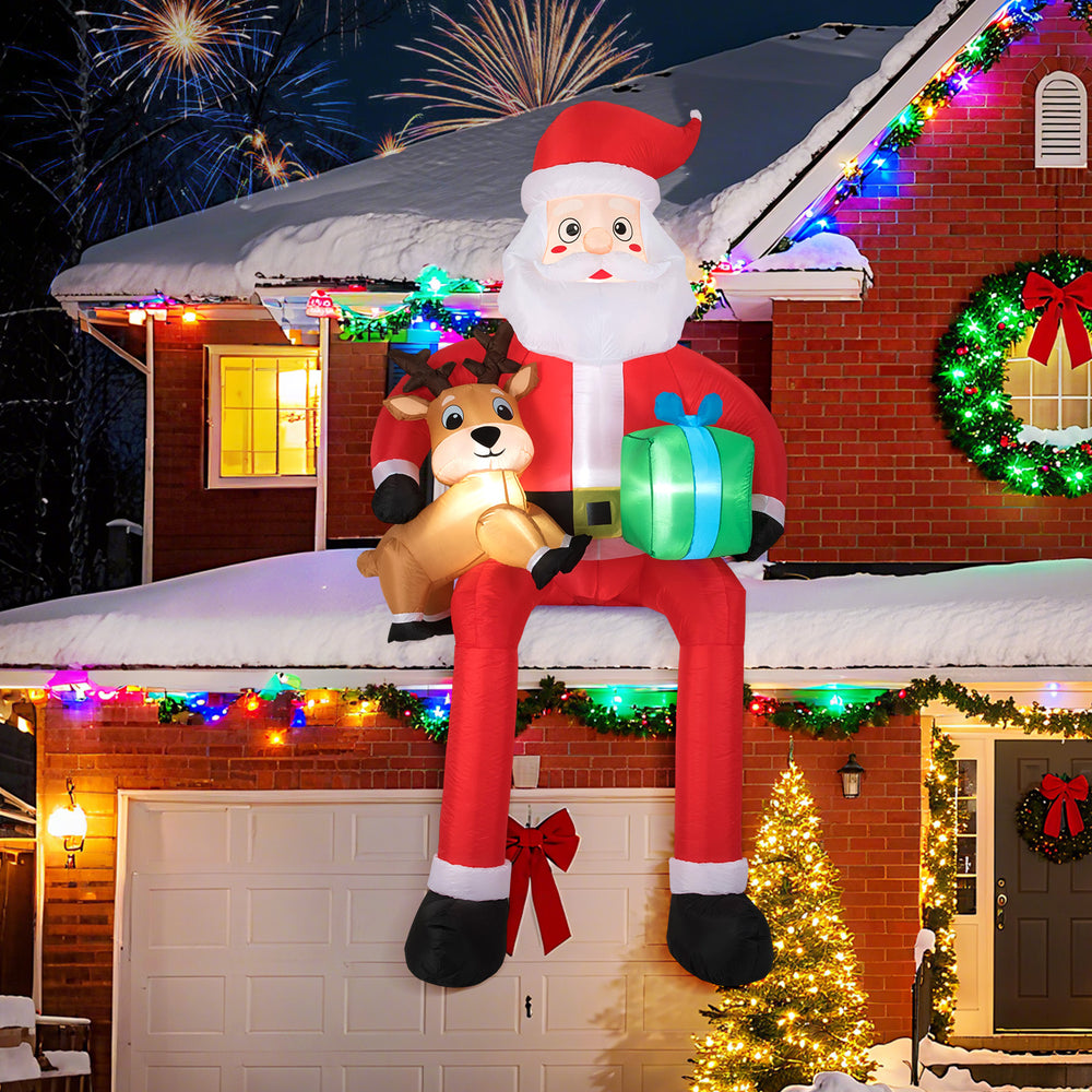 9.5 feet inflatable Santa Claus with LED lights, seated with a reindeer and gift box, ideal for festive outdoor.