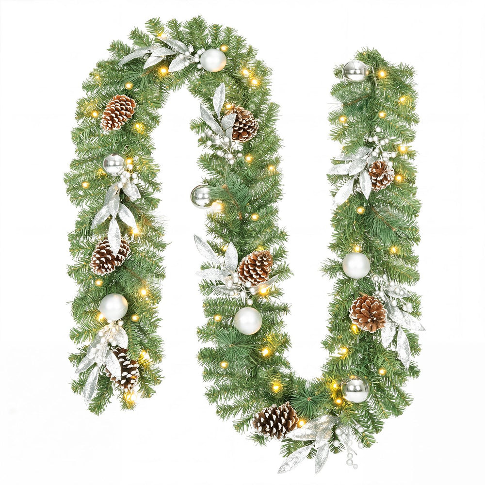 9FT pre-lit artificial Christmas garland featuring 50 warm white LED lights, pine cones, silver balls, and holly berries for festive decor.