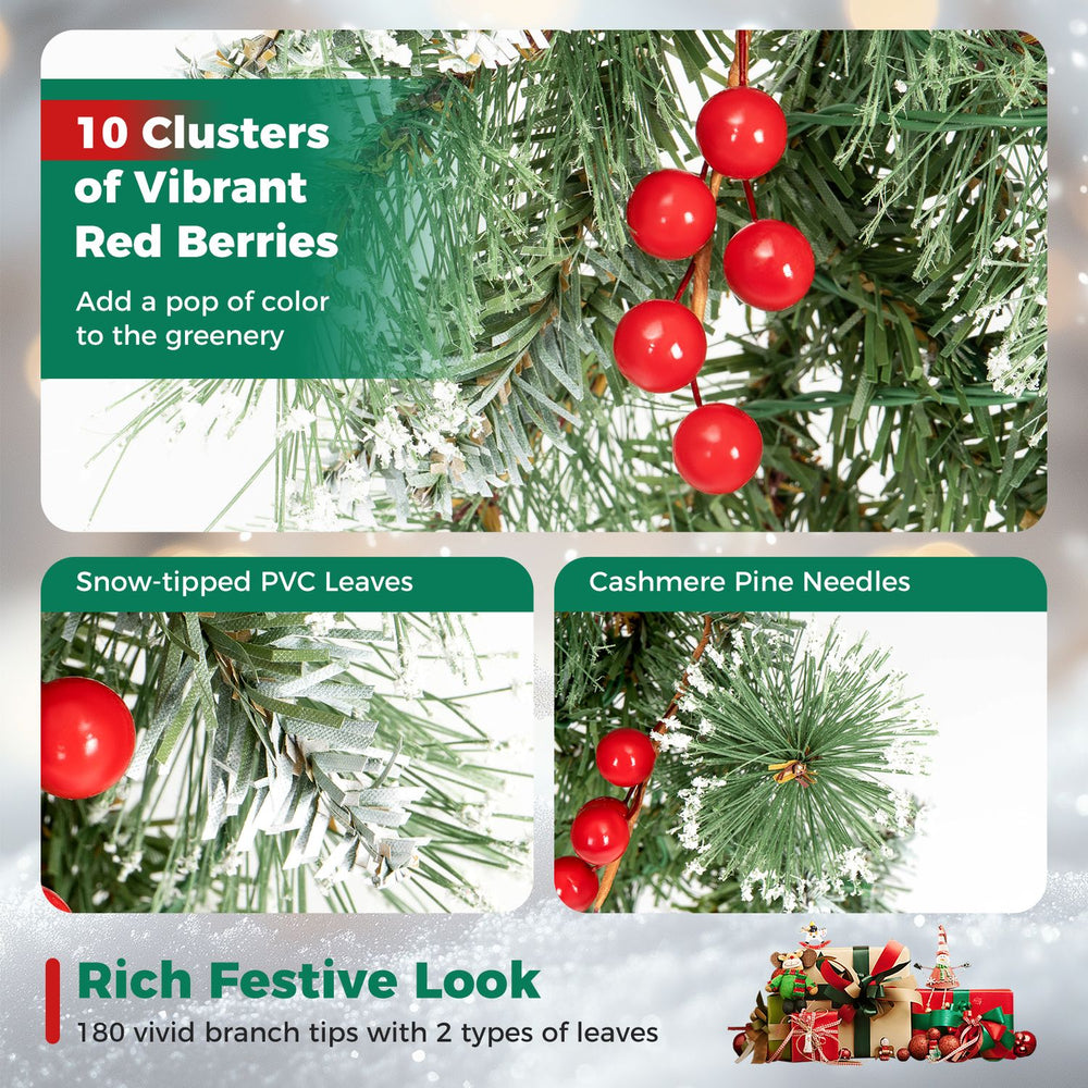 Close-up of red berries among snow-frosted PVC leaves on the 9 FT Christmas garland with 180 branch tips.