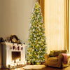 Pencil-shaped 6 FT artificial Christmas tree with warm-white LED lights, providing a cozy glow beside a decorated.