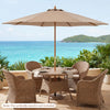 9 FT patio umbrella with brown bamboo ribs, providing sun protection for outdoor dining by the pool.